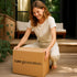 Woman happily unpacks a “raw generation” box on a porch, illustrating Shipping Assurance&