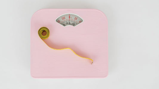 Pink scale with a tape measure. 