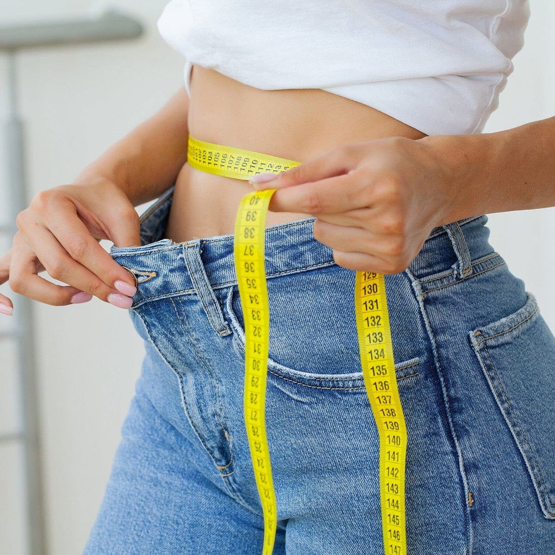 Girl measuring waist 