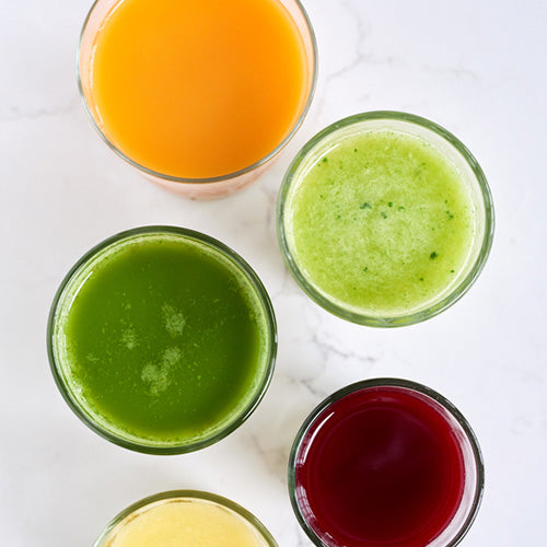 Aerial view of green juices poured into a cup
