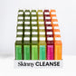 Display of 30 Skinny Cleanse® plastic juice bottles in a carton, featuring “Sweet Greens,” “Tarte Greens,” “Cool Greens,” “Sweet Roots,” and “Citrus Carrot” varieties.