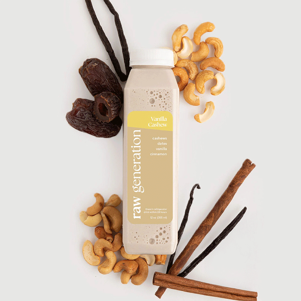Build-A-Box: 12 oz Raw Generation Vanilla Cashew nut-milk beverage with cashew nuts, Medjool dates, vanilla beans, and cinnamon sticks displayed around the bottle.