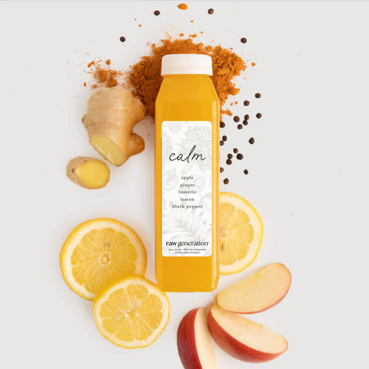 Bridal Calm juice by Raw Generation surrounded by fresh ingredients: ginger, turmeric, black peppercorns, lemon slices, and apple wedges, promoting immune support and vitality.