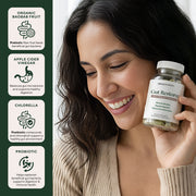 Woman holding Gut Restore Daily Debloat Formula bottle, highlighting 90 capsules with organic baobab, apple cider vinegar, chlorella, and probiotics designed for gut health support and digestive wellness.