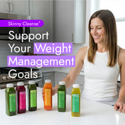 Woman with six Skinny Cleanse® cold-pressed juices on the counter, promoting weight management and detoxification through nutrient-rich, holistic support.