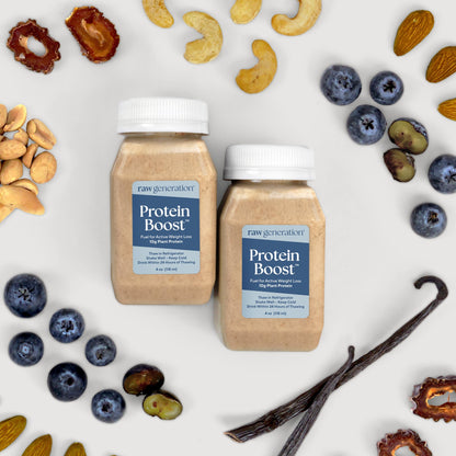 Two bottles of Protein Boost™ amid nuts and berries, showcasing its 10g plant protein, clean formula, and PB&J flavor, ideal for workouts.