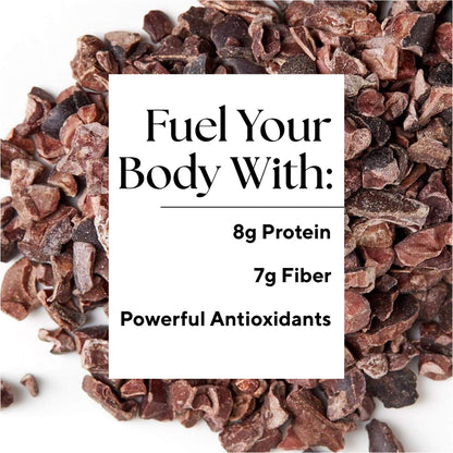 Close-up of sweet cacao nibs with a white box overlay. Text in the box reads: Fuel Your Body With: 8g Plant-Based Protein, 7g Fiber, Powerful Antioxidants, ideal for Raw Generations Cookies & Cream Smoothie. The text is surrounded by scattered cacao nibs on a white background.