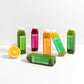 Beauty Box™ features six bottled cold-pressed juices, each labeled with names like “Tarte Greens” and “Sweet Roots,” promoting skin health with daily nourishing antioxidants.
