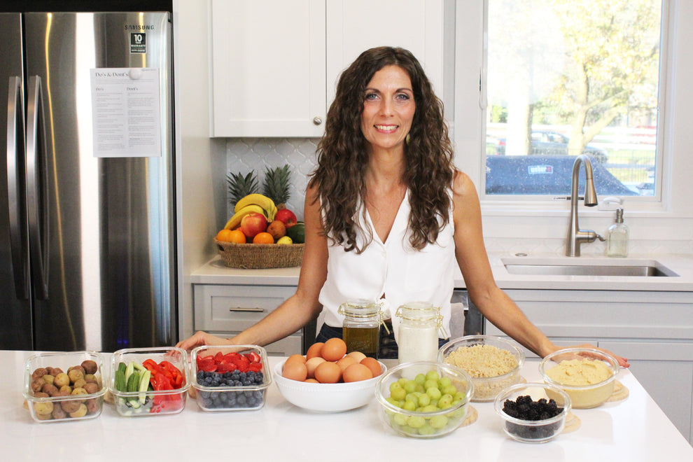 Woman in kitchen with table of food, promoting Label Reading: 10 Min. Video eCourse on understanding ingredient lists and health claims.
