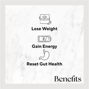 Sweet Roots Juice bottle on a white marble surface, featuring illustrations of a weight scale and stomach, promoting health benefits from ingredients like apples, carrots, beets, and lemon.