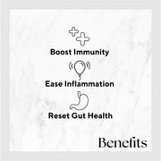 Ginger Turmeric juice bottle on white marble surface, featuring bold black text; a health-focused drink rich in Vitamin C and antioxidants.