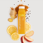 Ginger Turmeric juice bottle surrounded by lemon slices, apple, and ginger, highlighting its immune-boosting ingredients and Vitamin C-rich composition.